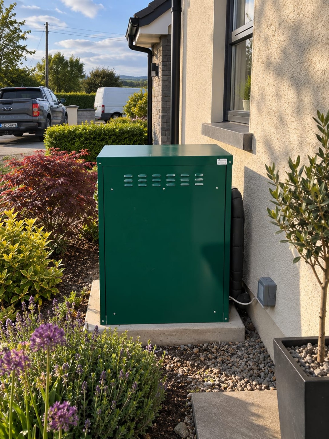 Green outdoor boiler installed beside a Cork home