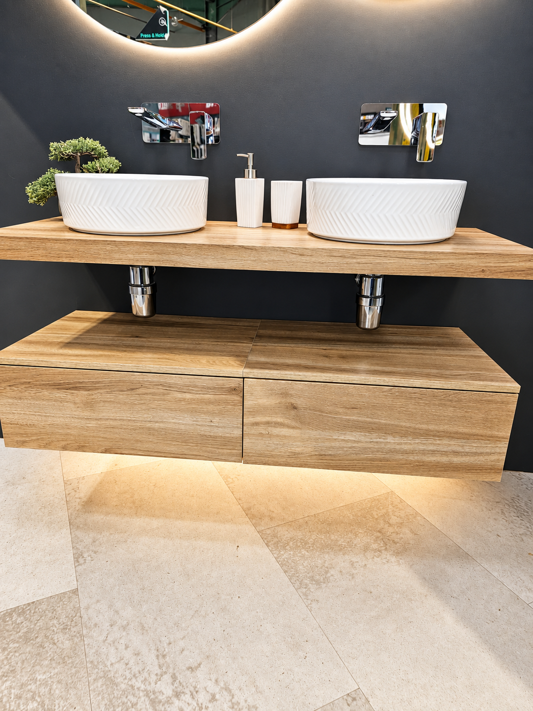 Double white vessel basins on a floating timber vanity with chrome taps